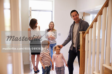 Realtor Showing Young Family Around Property For Sale