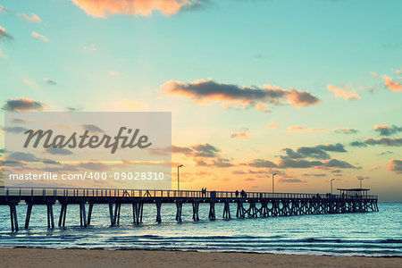 Beautiful sunset at Grange Jetty Adelaide Australia with people silhouettes