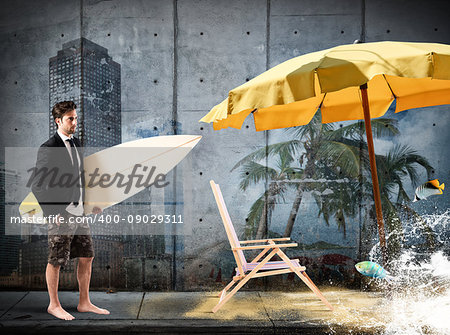 Businessman with surf board walking toward the sand