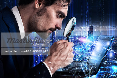 Man looks at the magnifying glass the screen of a laptop. Concept of software analysis