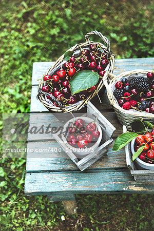 Fresh forest fruit on wood. Fresh organic fruit. Red cherries, blueberries and blackberries