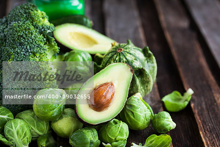 Assortment of fresh green vegetables on wooden table