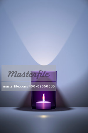 3d illustration of a candle in a purple glass with space for your content