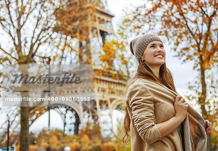 Autumn getaways in Paris. Portrait of happy young elegant woman in Paris, France looking into the distance