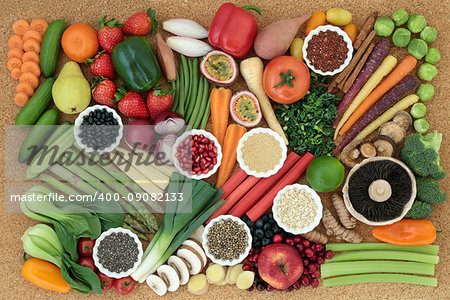 Superfood for healthy diet concept with fresh vegetables, fruit, legumes, seeds, grains and cereals with foods high in omega 3, anthocyanins, antioxidants, dietary fiber, vitamins and minerals. Top view on cork  background.