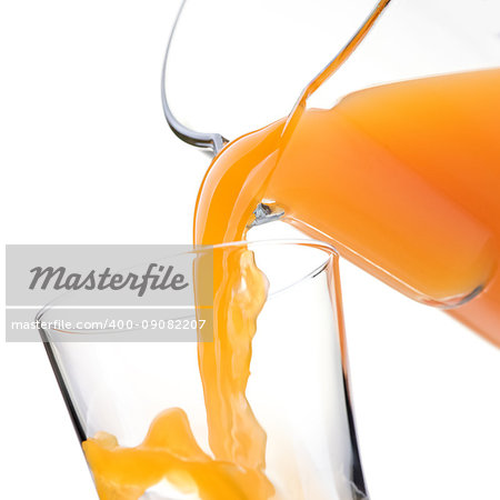 Pouring refreshing natural orange juice into a glass: nutrition and healthy drinks