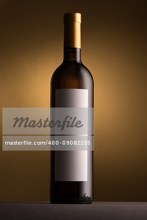 Excellent white wine bottle with blank label on golden background