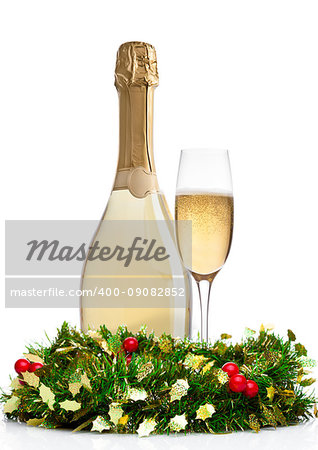 Bottle and glass of champagne with christmas decoration on white background