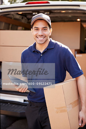 Portrait Of Courier With Digital Tablet Delivering Package