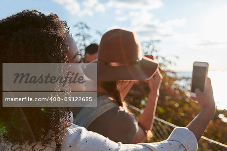 Group Of Tourists Taking Photos On Mobile Phones