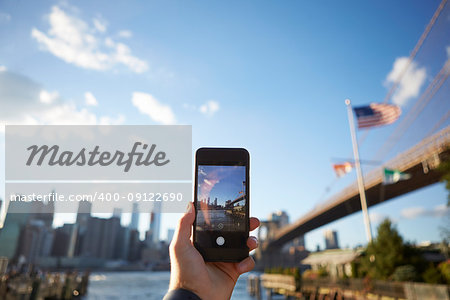 Tourist Taking Photo Of Manhattan Skyline On Mobile Phone