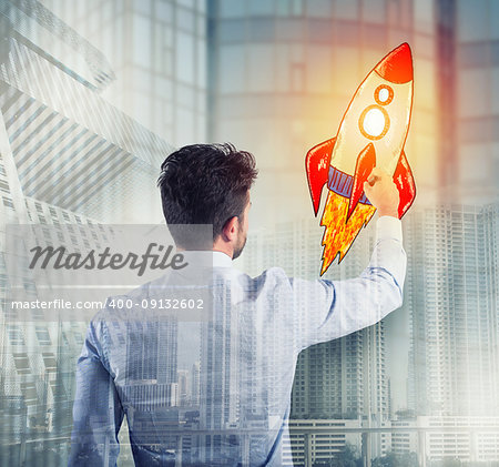 Businessman drawing a fast rocket. Concept of business improvement and enterprise startup