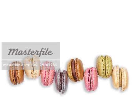 French colorful macarons dessert cakes top view on white background