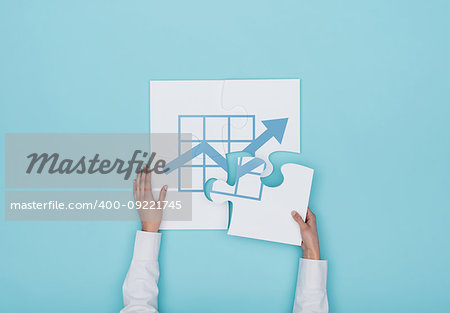 Woman completing a puzzle with a financial graph icon, she is putting the missing piece, finance and business solutions concept