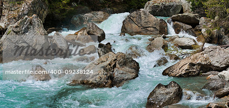 the rapids of the river that flows between the rocks during the melting snow