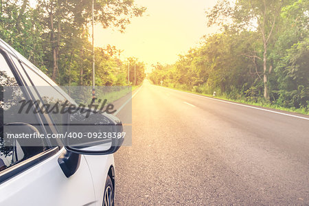 Close up on white car parking on the road in countryside