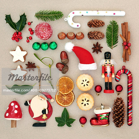 Traditional symbols of Christmas selection with food, old fashioned retro decorations and winter flora with berries, leaf sprigs and natural objects.