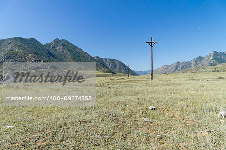 Small power line in the Altai mountains, Russia. Sunny summer day.