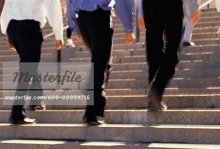 Back View of Businessmen Walking Up Steps Outdoors