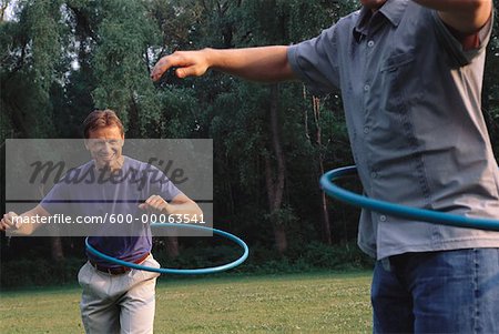 Men Using Hula Hoops Outdoors