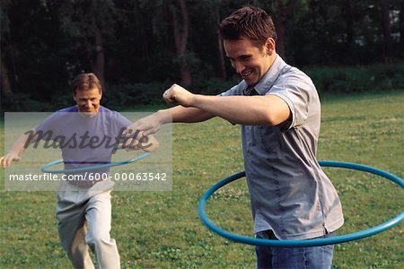 Men Using Hula Hoops Outdoors