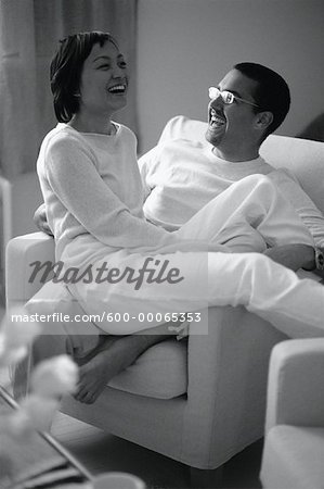 Couple Sitting in Chair, Laughing