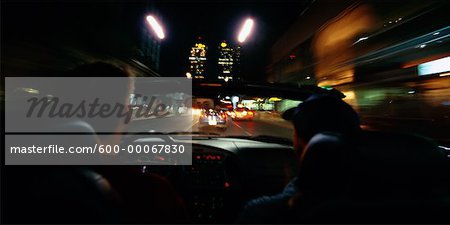 Two Men Driving in Car at Night, Toronto, Ontario, Canada
