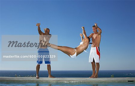 Men Throwing Woman Into Swimming Pool