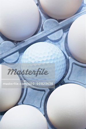 Eggs in Carton With Golf Ball