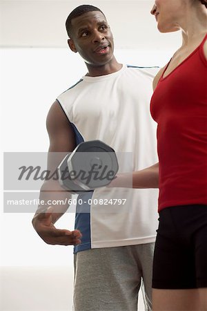 Man and Woman Lifting Weights