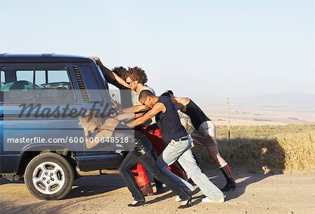 people pushing a car