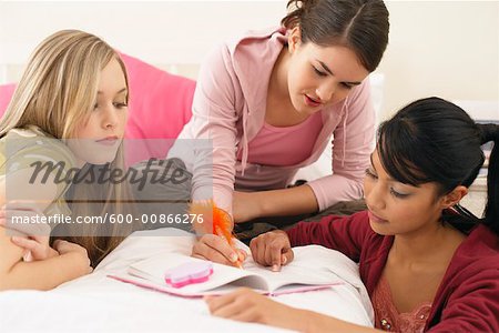 Girls Doing Homework in Bedroom