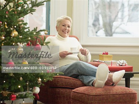 Woman in Chair by Christmas Tree
