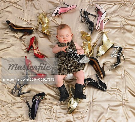 Baby Surrounded by Shoes