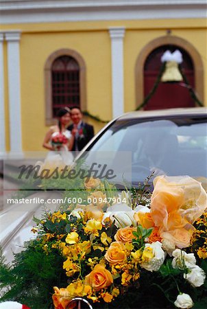 Car Decorated for Wedding, Bride and Groom in Background