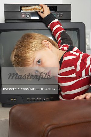 600-00948167em-boy-inserting-sandwich-into-vcr-stock-photo.jpg