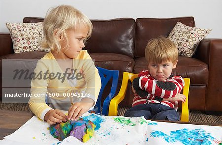 Brother and Sister Playing with Plasticine