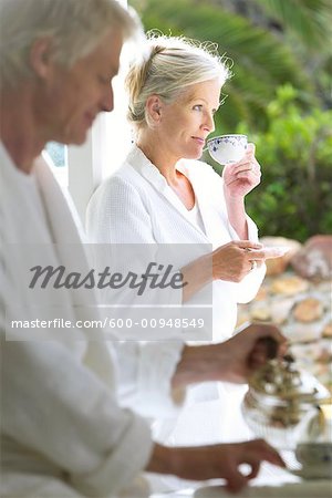 Couple Drinking Morning Coffee On Terrace