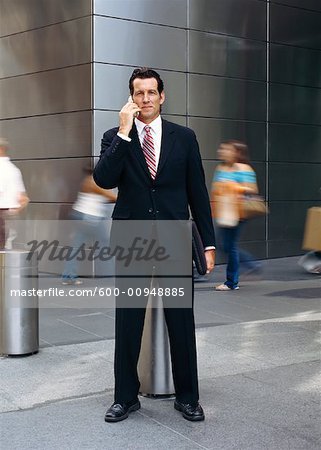 Portrait of Businessman Standing Outdoors, Talking On Cellular Phone