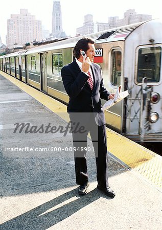 Businessman on Subway Platform, Talking on Cellular Phone Businessman on Subway Platform, Talking on Cellular Phone