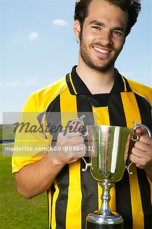 Portrait of Soccer Player Holding Trophy