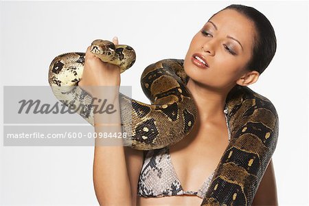 600 00984428em portrait of woman with boa constrictor wrapped around neck stock