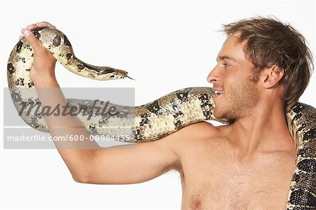 Close-up of Man and Snake Looking at Each Other