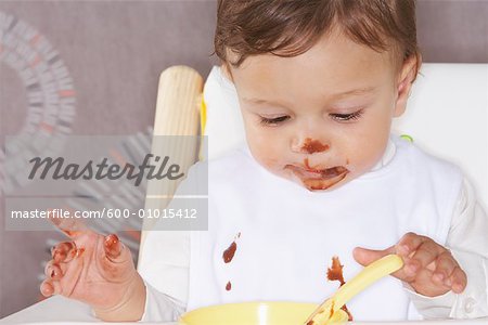 Baby in High Chair with Dessert