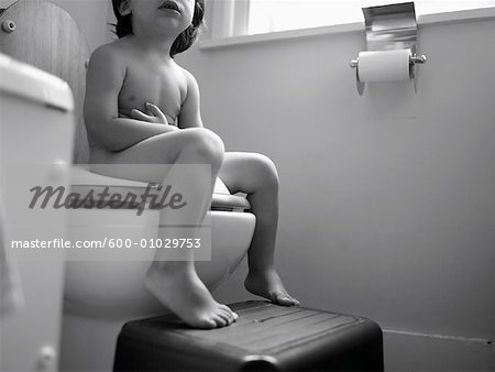 Child Sitting on Toilet
