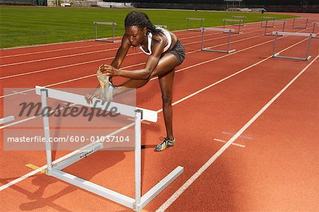 Woman Stretching at Hurdles