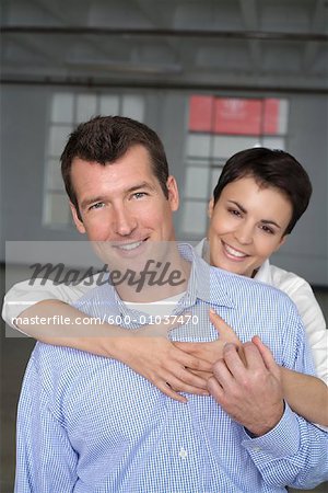 Portrait of Couple in Empty Loft Apartment