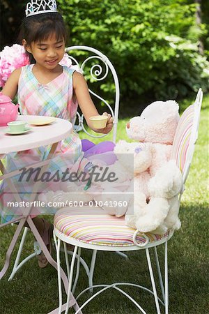 Girl Serving Tea at Tea Party