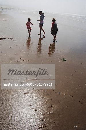 Family Walking on Beach, Oregon, USA