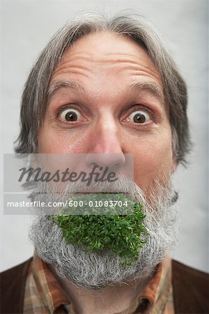 Man with Green Vegetable in Mouth